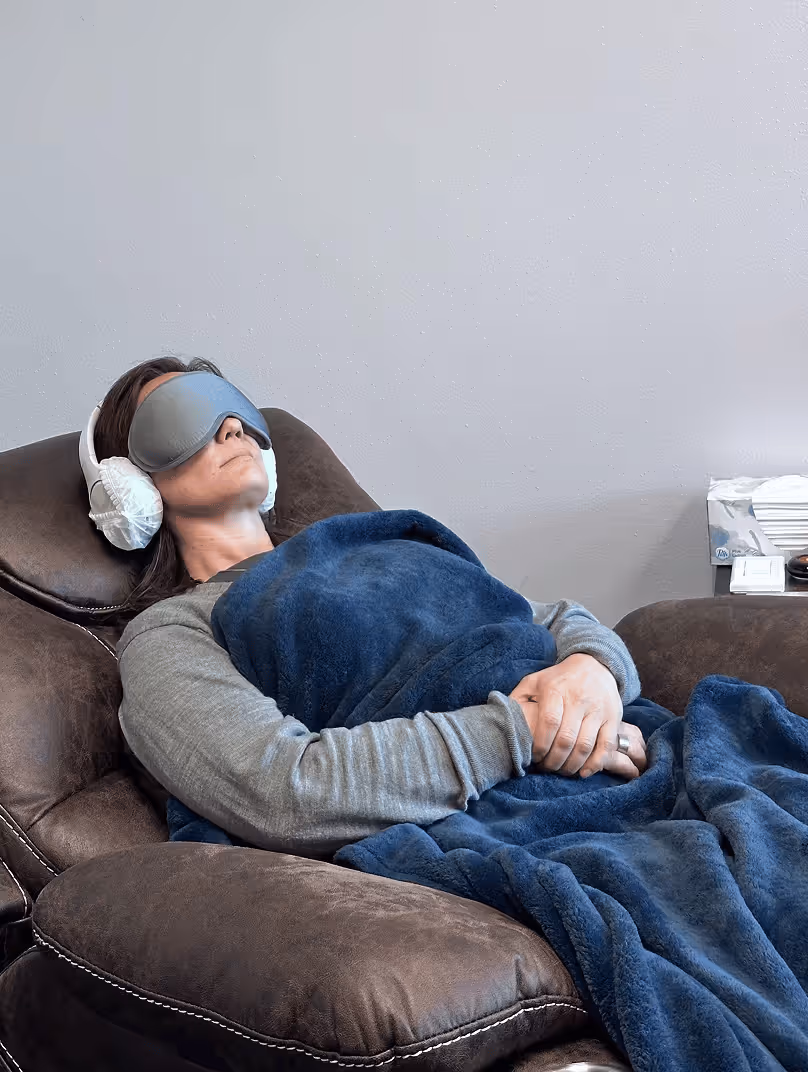A patient resting comfortably during a Ketamine-Assisted Psychotherapy session at Lonerock Clinic